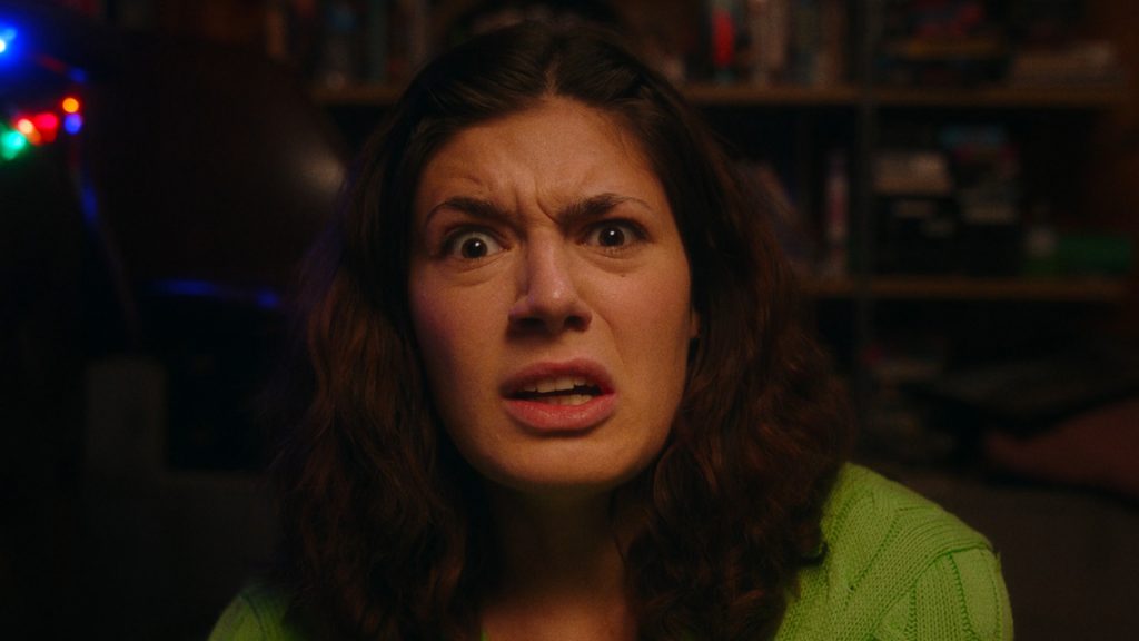 A still from the film KISSSING. A women looks disgusted at camera.
